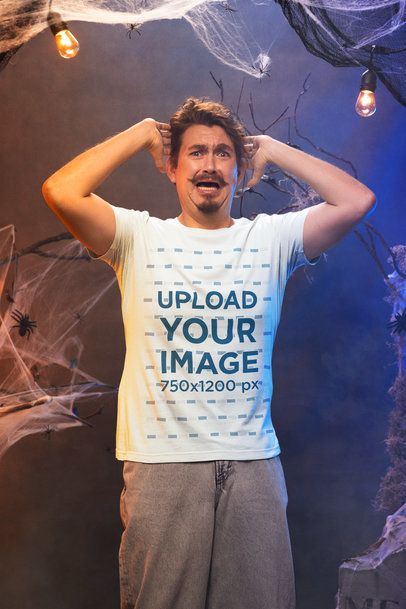 Mockup Featuring a Scared Man Wearing a Bella Canvas T-Shirt in a Haunted House