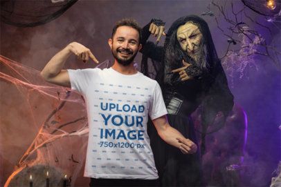 Halloween-Inspired Mockup of a Happy Man Pointing at His Bella Canvas T-Shirt