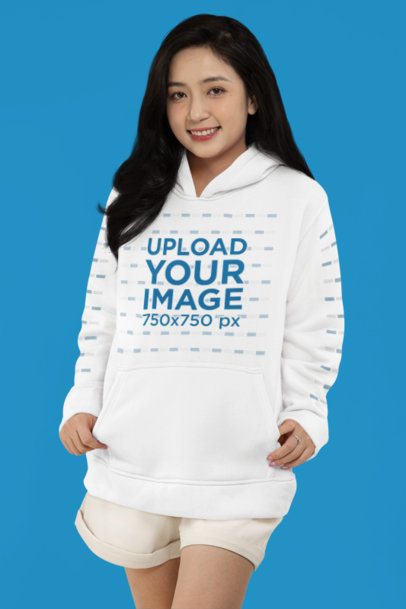 Mockup of a Smiling Woman Wearing a Pullover Hoodie with Customizable Sleeves