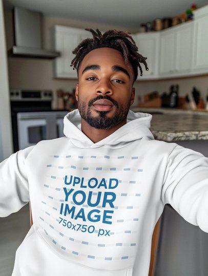 Pullover Hoodie Mockup of an AI-Created Man Taking a Selfie in His Kitchen