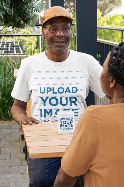 T-Shirt and Coffee Mug Mockup of an Elderly Man Talking with His Wife at a Restaurant  m51505
