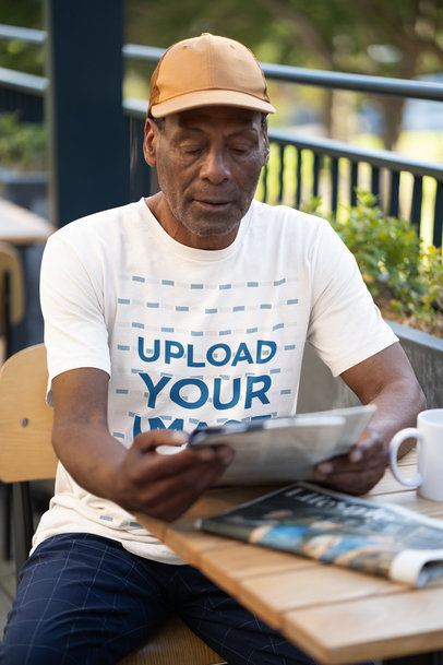Bella Canvas T-Shirt Mockup of an Elderly Man Reading the Newspaper