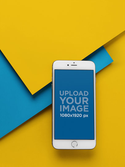 Silver iPhone 8 Plus Mockup Floating Over Three Pasteboards