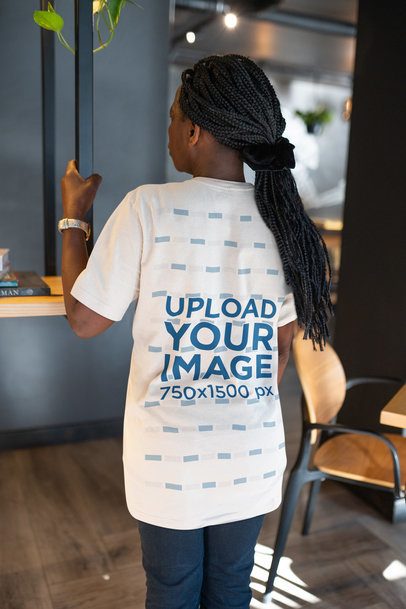 Back-View Bella Canvas Tee Mockup of an Elderly Woman Standing in an Indoor Setting