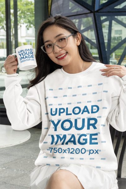 Sweatshirt Mockup Featuring a Happy Woman with Glasses Holding an 11 oz Coffee Mug