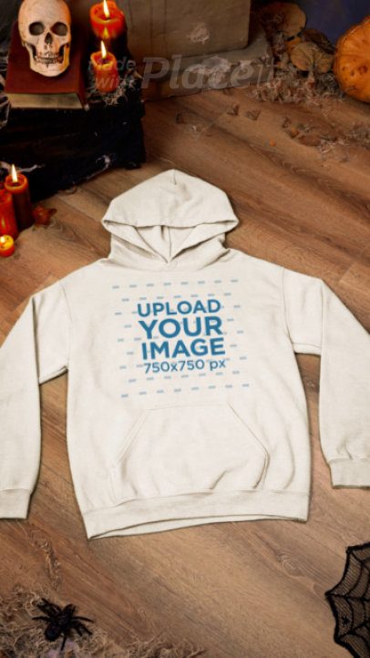 Haunted-Themed Video of a Gildan Hoodie Placed on a Wooden Surface With Halloween Decorations