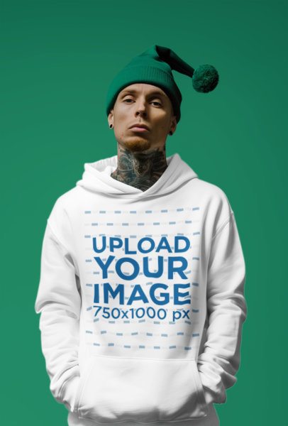 Hoodie Mockup Featuring an AI-Created Tattooed Man With a Christmas Green Hat