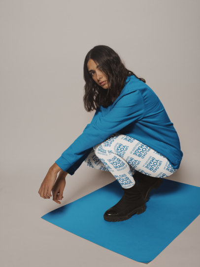 Side Shot Leggings Mockup of a Woman Crouching on a Pasteboard