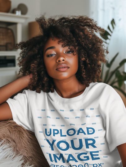 Round-Neck T-Shirt Mockup Featuring an AI-Created Afro-Hairstyled Woman Resting on a Couch m51558