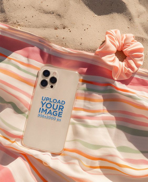 Print Mockup Featuring an AI-Created Phone Clear Case Lying on the Sand With a Scrunchie
