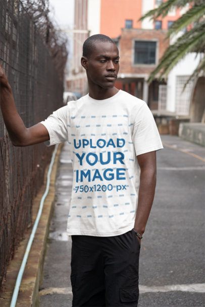 Mockup of a Man Wearing a Crewneck T-Shirt with a Rounded Neck on an Empty Street m50389