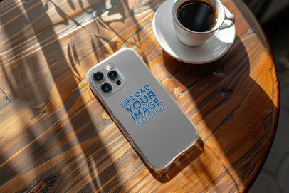 Clear iPhone 15 Pro Case Mockup of a Device Placed Upside Down on a Wooden Table