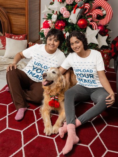 Bella Canvas T-Shirt Mockup Featuring Two Smiling Women With Their Dog in a Christmas-Decorated Room