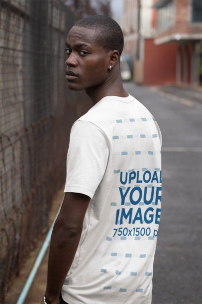Back-View Bella Canvas T-Shirt Mockup Featuring a Man Looking over His Shoulder