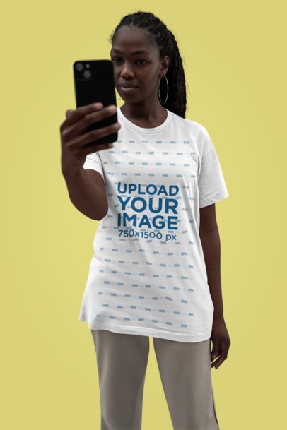 Bella Canvas Tee Mockup Featuring a Woman Taking a Selfie with Her Smartphone