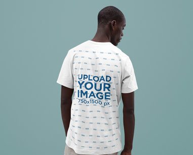 Back-View T-Shirt Mockup Featuring a Man Standing in a Studio with a Solid Background