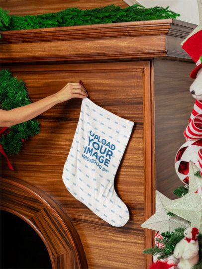 Mockup of a Person Putting a Christmas Stocking on a Wooden Fireplace m52066