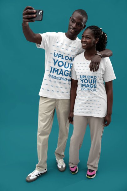 Bella Canvas T-Shirt Mockup of a Happy Couple Taking a Selfie Together in a Studio