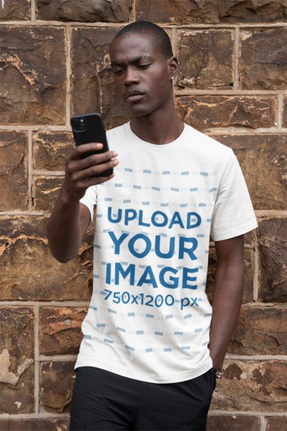 Bella Canvas Rounded-Neck T-Shirt Mockup Featuring a Man Checking His Smartphone