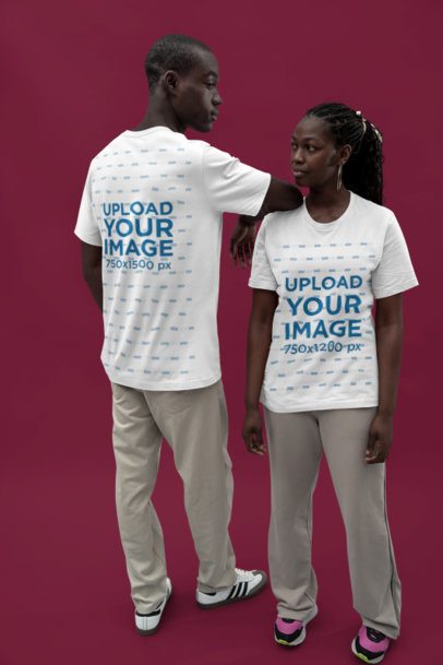 Bella Canvas T-Shirt Mockup of a Couple Wearing Matching Outfits in a Studio