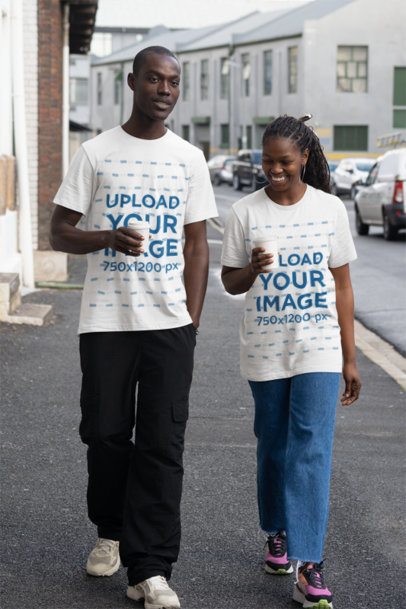 Oversized T-Shirt Mockup of a Man and a Woman Walking Together on the Street 