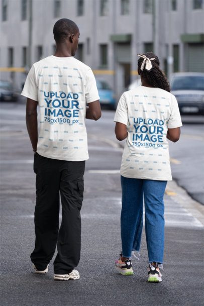 Back-View T-Shirt Mockup Featuring a Man and a Woman Walking on the Street