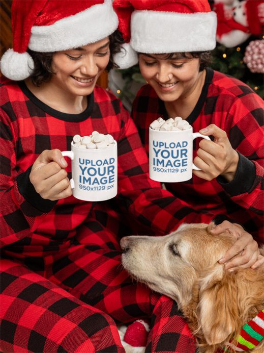 Mockup of Two Women in Christmas Outfits Holding Coffee Mugs and Petting Their Dog