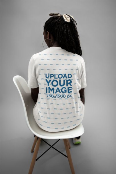 Back-View Bella Canvas T-Shirt Mockup Featuring a Woman Sitting on a Chair