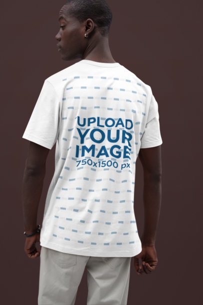 Back-View Bella Canvas Tee Mockup Featuring a Man with an Ear Ring in a Studio