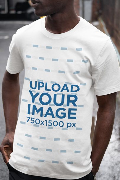 Mockup Featuring a Man Wearing a Rounded-Neck Bella Canvas Tee on the Street