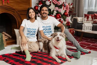T-Shirt Mockup of a Smiling Couple Posing with Their Dog in a Christmas-Decorated Setting