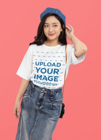 Mockup of a Smiling Woman Wearing an Oversized T-Shirt and Denim Garments in a Studio