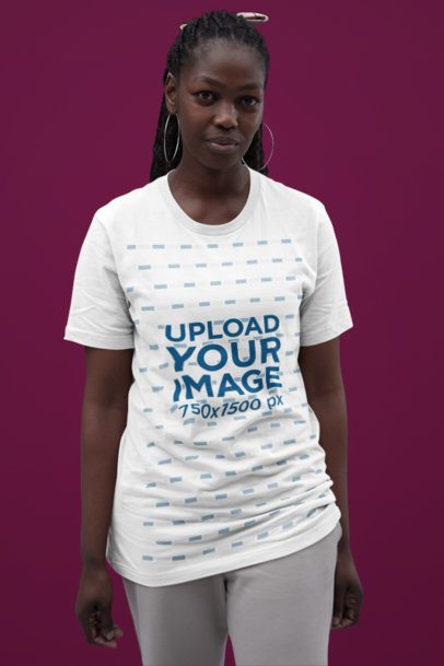 Studio Mockup Featuring a Woman with Big Earrings Wearing a Bella Canvas Tee