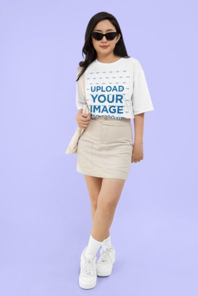 Mockup of a Woman with Sunglasses Wearing a Rounded-Neck T-Shirt in a Studio