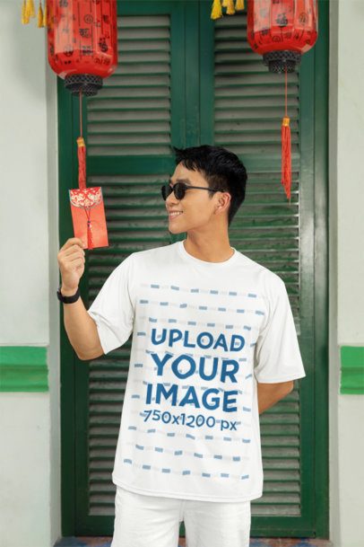 T-Shirt Mockup of a Smiling Man Holding a Lunar Year Envelope  m52223