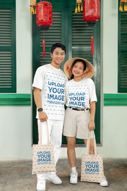 Oversized T-Shirt Mockup Featuring a Happy Couple With Tote Bags Celebrating Chinese New Year m52228