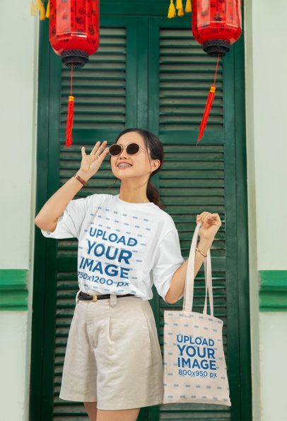 Lunar Year-Themed Mockup of a Happy Woman Wearing a T-Shirt and Carrying a Tote Bag m52218