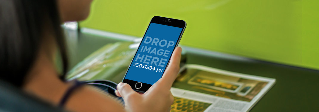 Mockup of a Woman Reading a Magazine and Using an iPhone 6