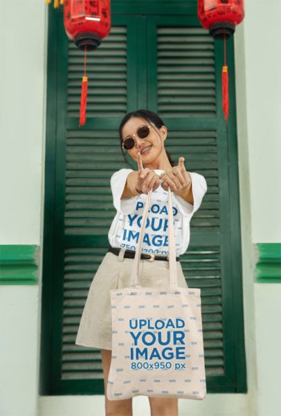 Oversized T-Shirt Mockup Featuring a Happy Woman Carrying a Tote Bag for Lunar New Year m52219
