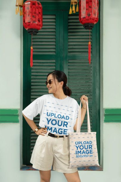 Oversized Tee Mockup of a Smiling Woman Posing With a Tote Bag for Lunar New Year m52220