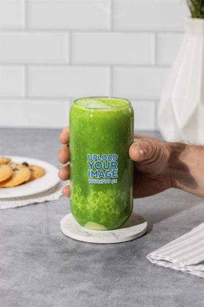 Drinkware Mockup Featuring a Man Holding a Can Glass Filled With Green Juice m52443