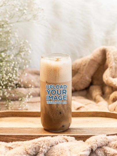 Mockup of a 20 Oz Glass Can Filled With an Iced Latte in a Cozy Setting m52428