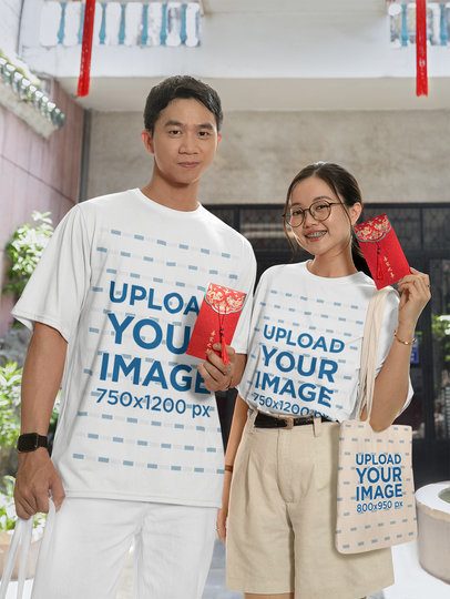 Oversized T-Shirt and Tote Bag Mockup Featuring a Smiling Couple With Lunar New Year Cards m52206