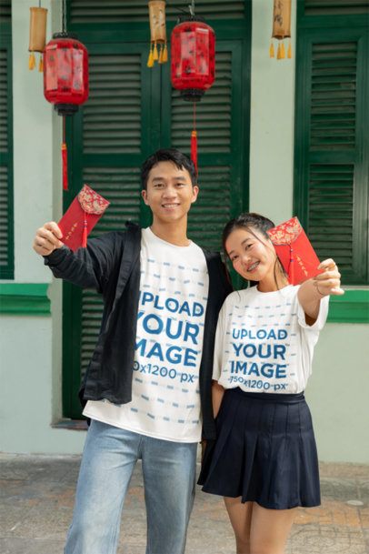 T-Shirt Mockup Featuring a Couple Holding Red Envelopes for the Chinese New Year m52235