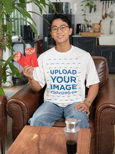 Lunar Year-Themed Mockup of a Smiling Man Wearing a T-Shirt and Holding Red Envelopes m52239