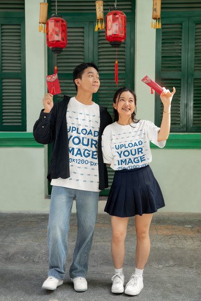 T-Shirt Mockup Featuring a Man and a Woman Holding Red Envelopes for the Lunar Year m52236