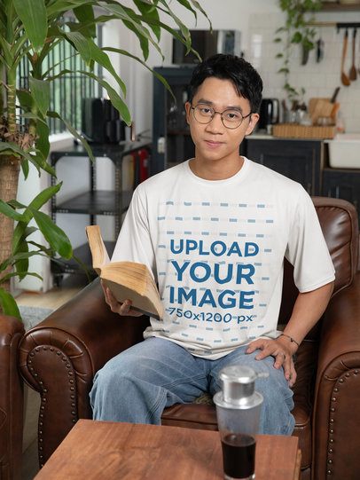 Lunar Year-Themed Mockup of a Man in a T-Shirt Reading a Book at Home m52238