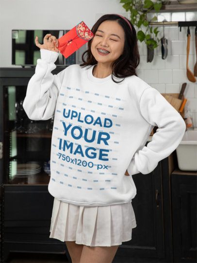 Sweatshirt Mockup of a Smiling Woman Celebrating the Lunar Year with a Red Envelope m52254