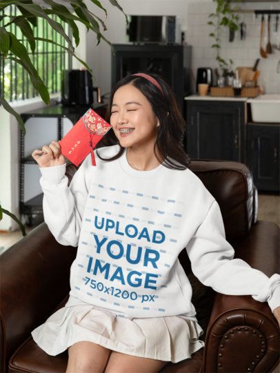Sweatshirt Mockup of a Happy Woman with a Red Envelope Celebrating the Chinese New Year m52255