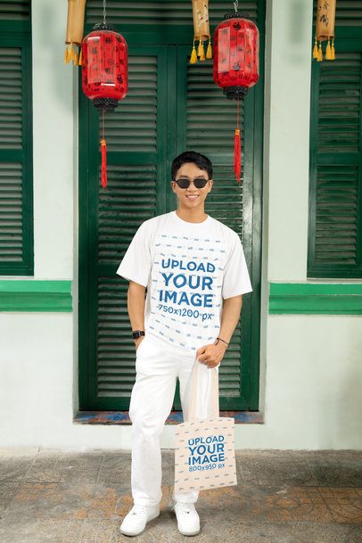 T-Shirt and Tote Bag Mockup of a Smiling Man Standing in a Lunar Year-Decorated Setting m52224